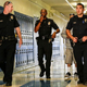 Police officers walking down a hallway of a school.